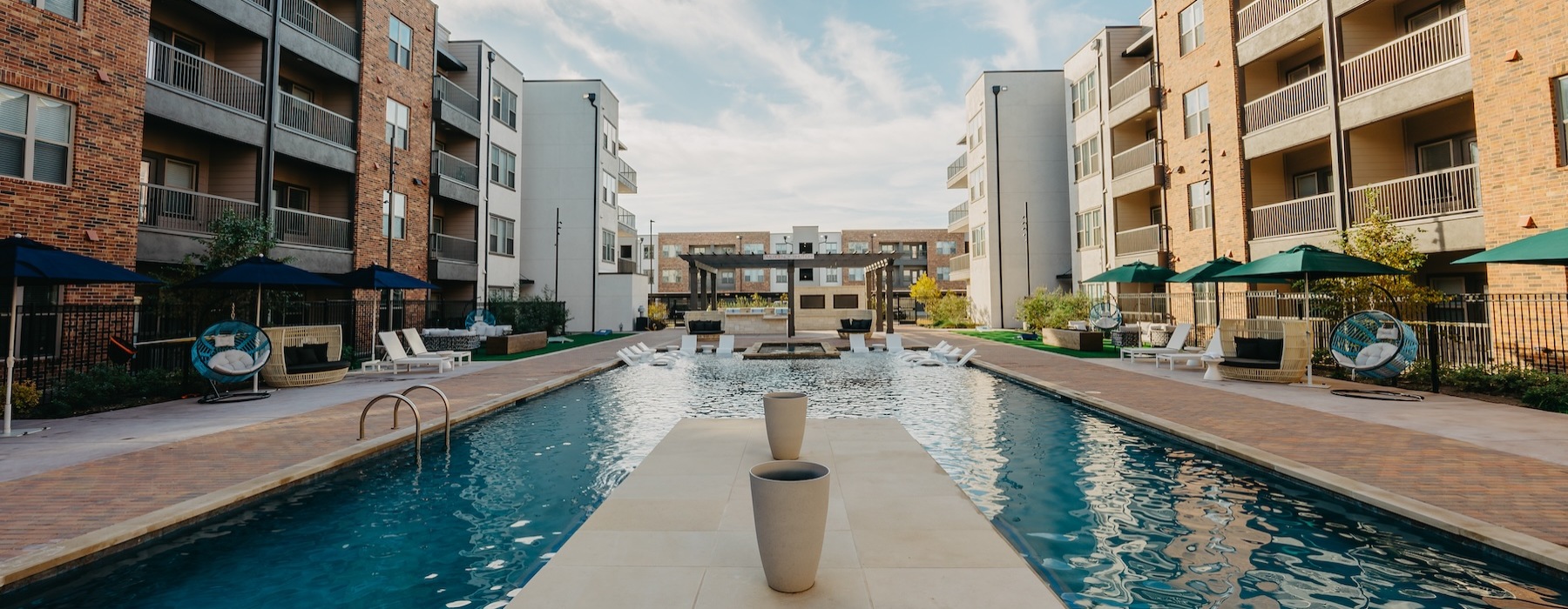 Resort-style swimming pool with lounge seating